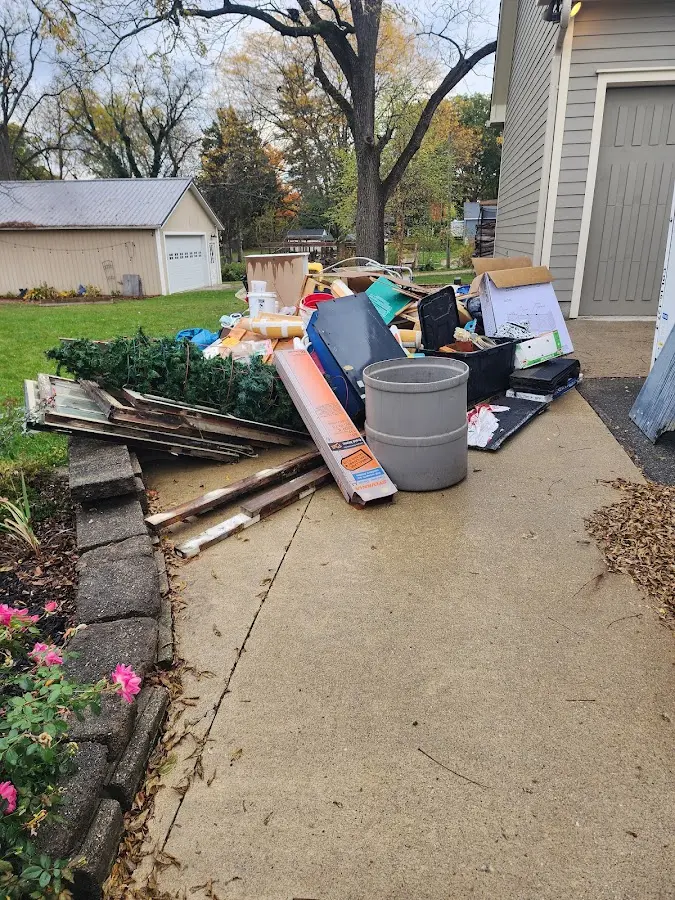 Dumpster being loaded with debris for 12 Yard Dumpster Rental in Springfield